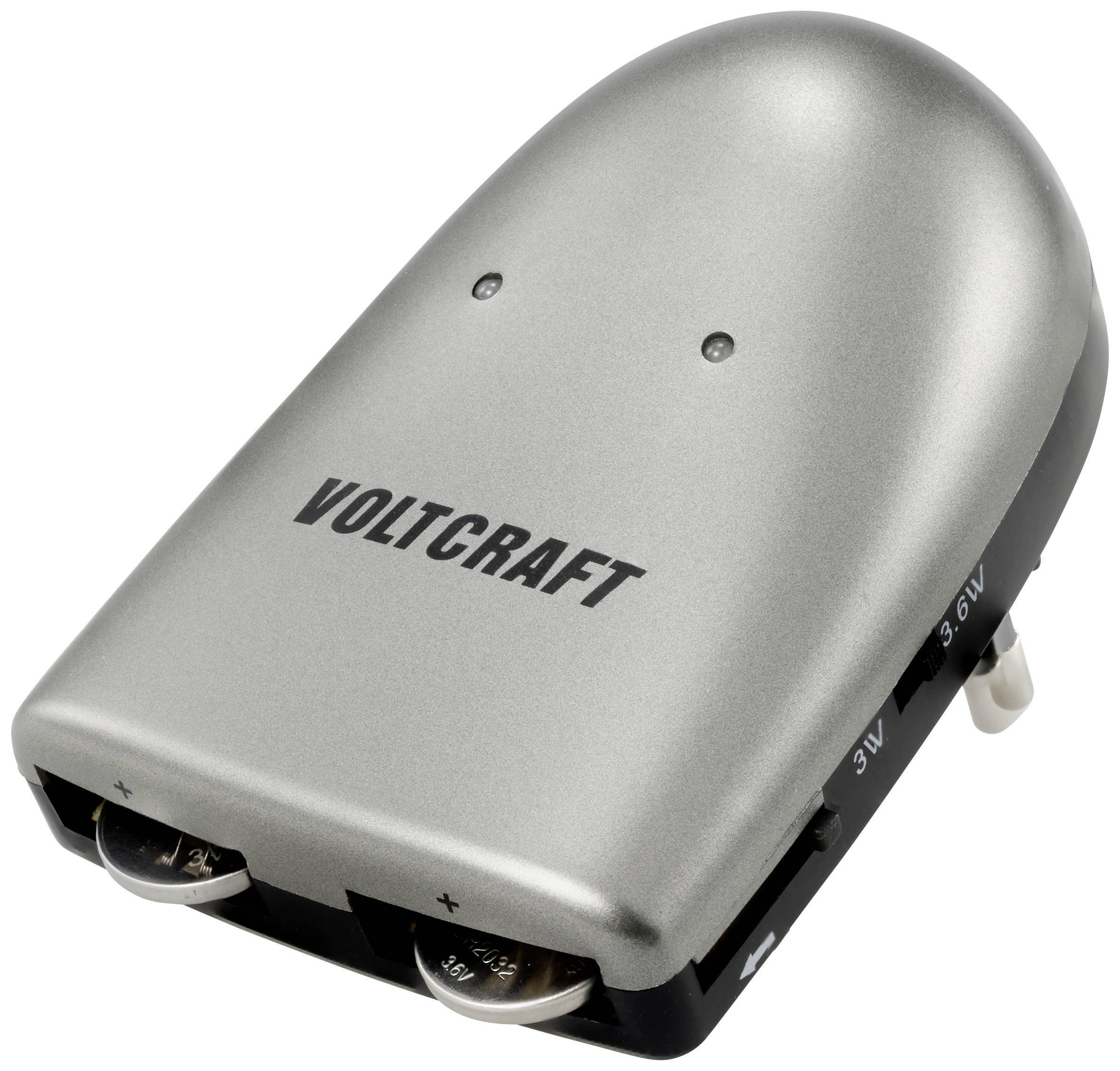 Un chargeur de batterie argenté de la marque 'Voltcraft' avec des options de réglage pour différentes tensions et deux emplacements de charge.