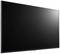 Un grand téléviseur noir à écran plat avec un cadre fin, vu de côté. L'écran est éteint.