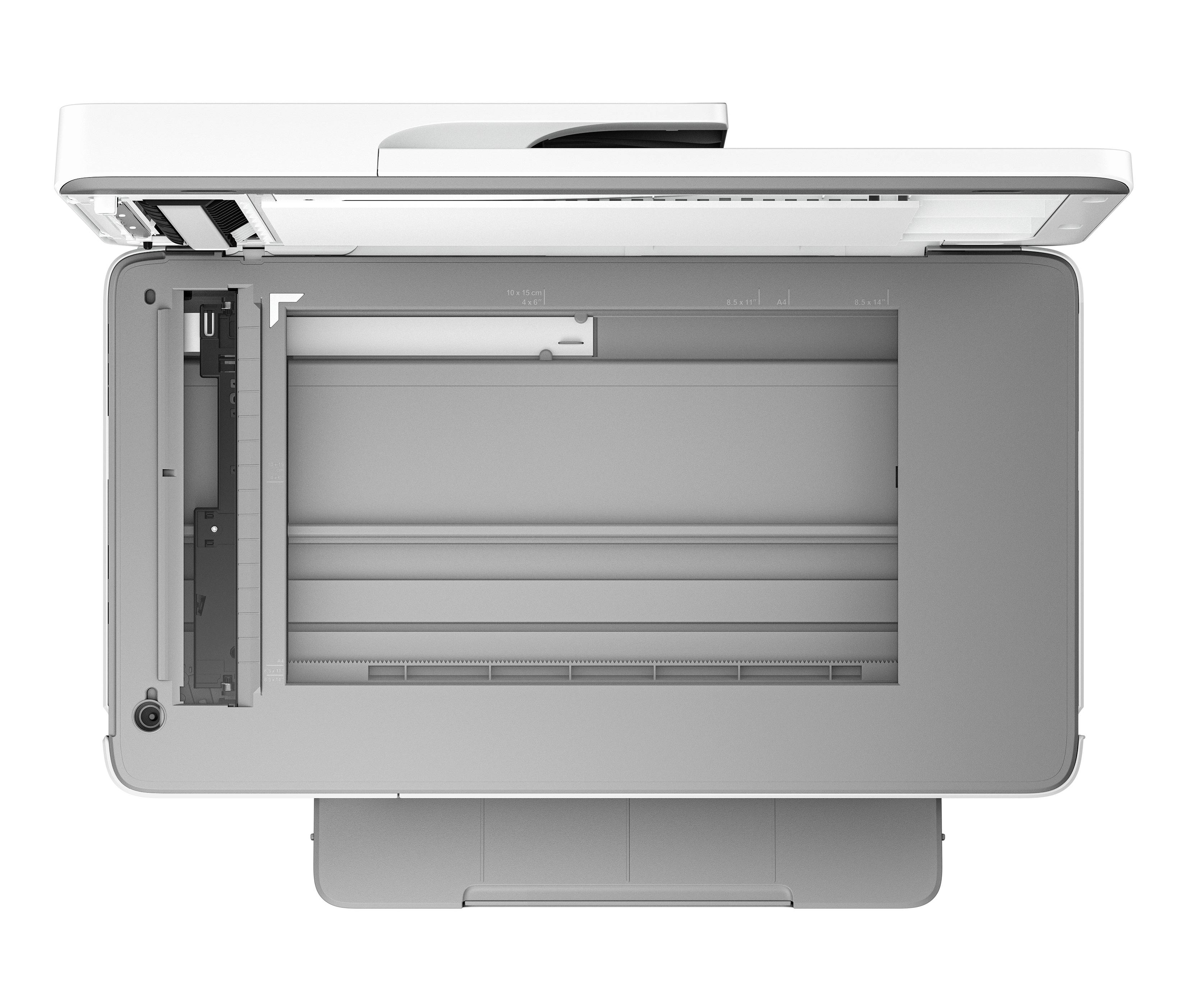 Vue de dessus d'une photocopieuse ou d'un imprimante multifonction ouverte, avec la surface du scanner et l'alimentation papier visibles.