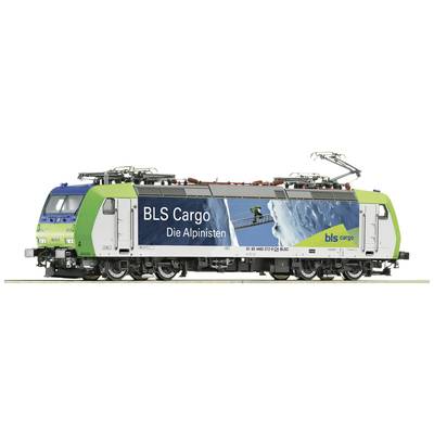 L'illustration montre une locomotive BLS Cargo, ornée d'une image d'un grimpeur et portant l'inscription 'Les Alpinistes'.