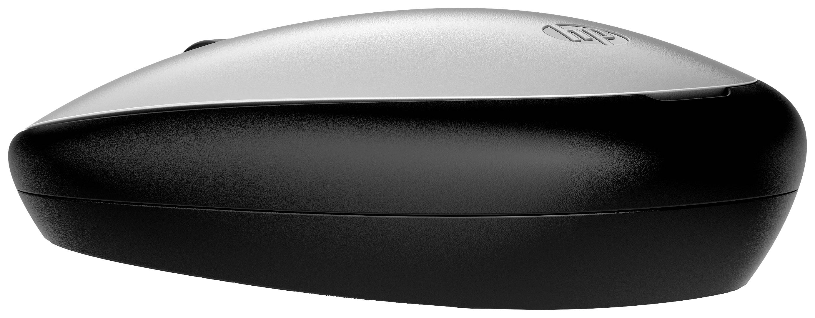 Souris d'ordinateur fine et sans fil en noir et argent, vue de côté, adaptée aux travaux précis sur différentes surfaces.