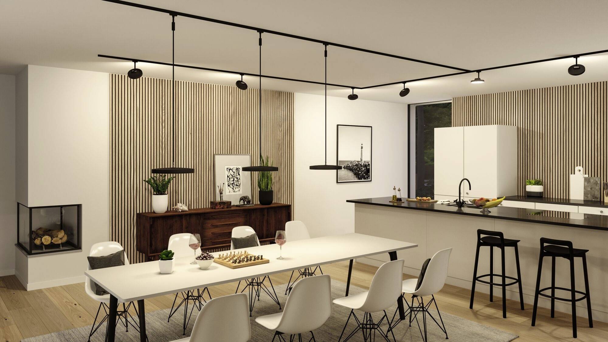 Cuisine ouverte et salle à manger au design moderne. Une longue table à manger avec des chaises blanches est placée devant un îlot central équipé de tabourets de bar.