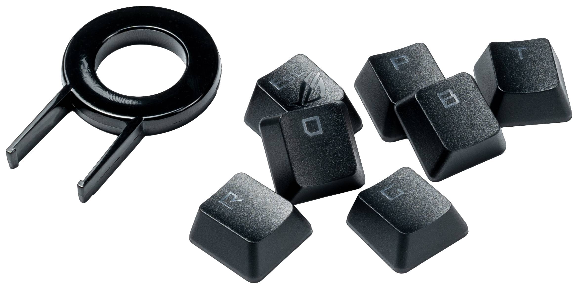 'Image d'un outil de retrait de touches et de plusieurs touches mécaniques posés sur une table.'