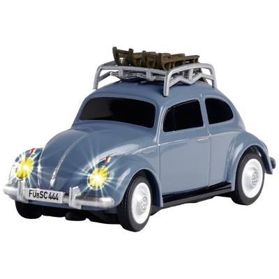 Voiture miniature au design classique, bleue, avec un porte-bagages sur le toit, phares allumés. Numéro de licence 'FüSC 444'.