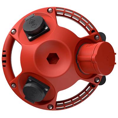 Dispositif technique rond et rouge avec plusieurs connexions et un motif en losange sur le dessus, sur un fond noir.
