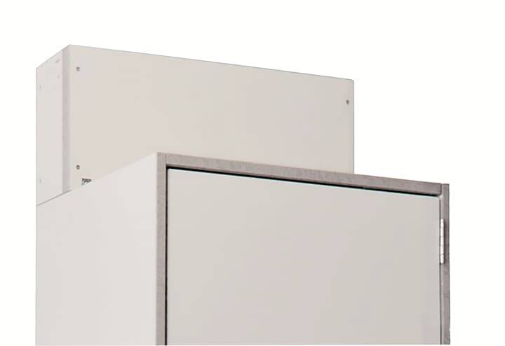 Un placard blanc avec une petite boîte blanche supplémentaire posée dessus, sur un fond blanc.