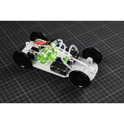Une petite voiture modèle transparente avec des pièces vertes et noires sur un fond à carreaux, illustrant un design technique et robotique.