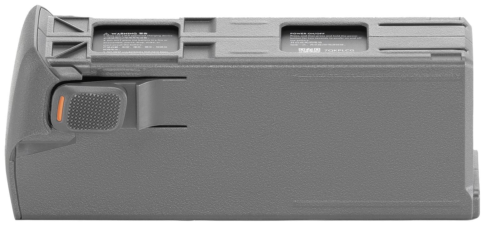 Un magazine gris aux surfaces structurées et avec des accents orangés. Il comporte deux petites étiquettes d'information sur le dessus.