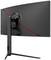 Un grand moniteur incurvé avec un boîtier noir et un accent rouge à l'arrière. Le moniteur est posé sur un support élancé.
