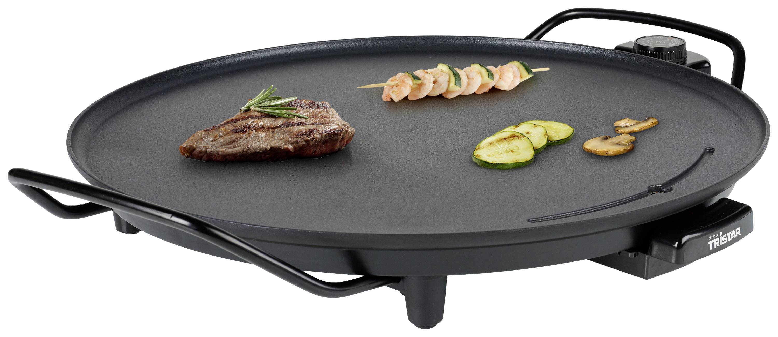 Plaque de grill électrique avec un steak grillé, des brochettes de légumes et des champignons, idéale pour préparer simultanément différents plats.