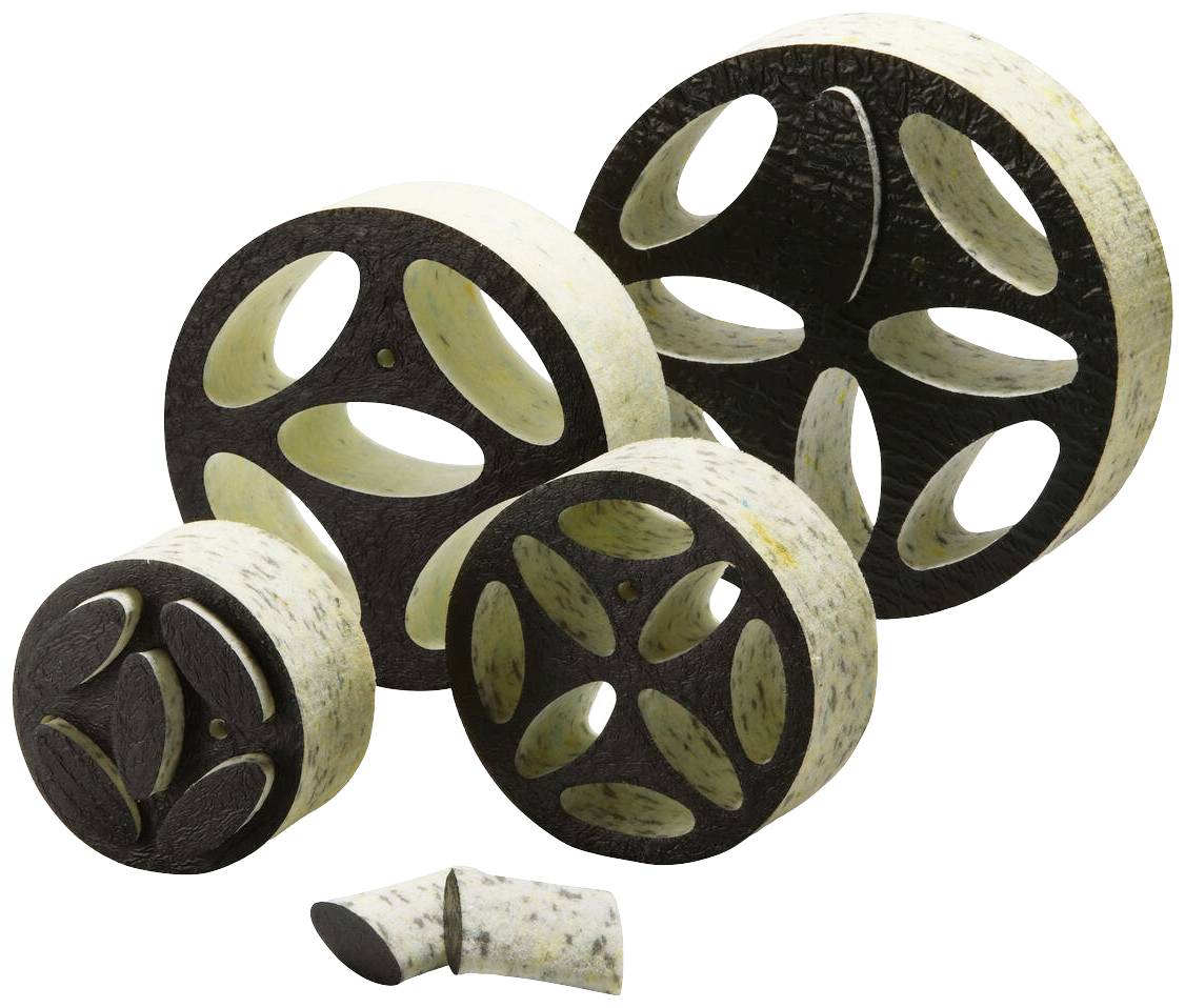 Plusieurs tubes décoratifs avec des découpes en forme de fleur, en matériaux noir et blanc, disposés sur une surface blanche.