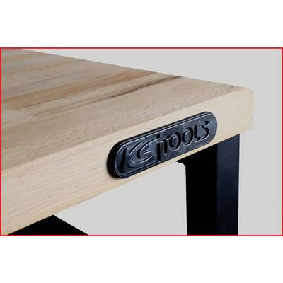 Plateau de table en bois avec cadre en métal. Un écusson métallique portant l'inscription 'KS TOOLS' est fixé sur le bord de la table.