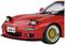 Une voiture de sport rouge avec des phares ouverts, des jantes dorées et une plaque d'immatriculation 'RX-7', photographiée de trois-quarts avant.
