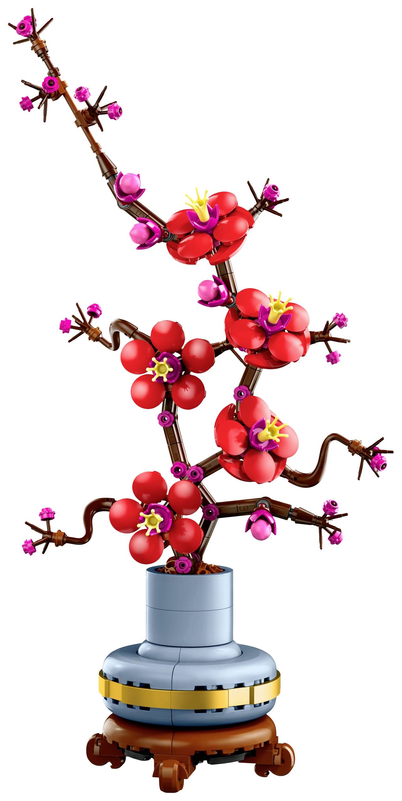 Une représentation décorative d'un cerisier japonais en briques LEGO, avec des fleurs rouges sur un socle gris.