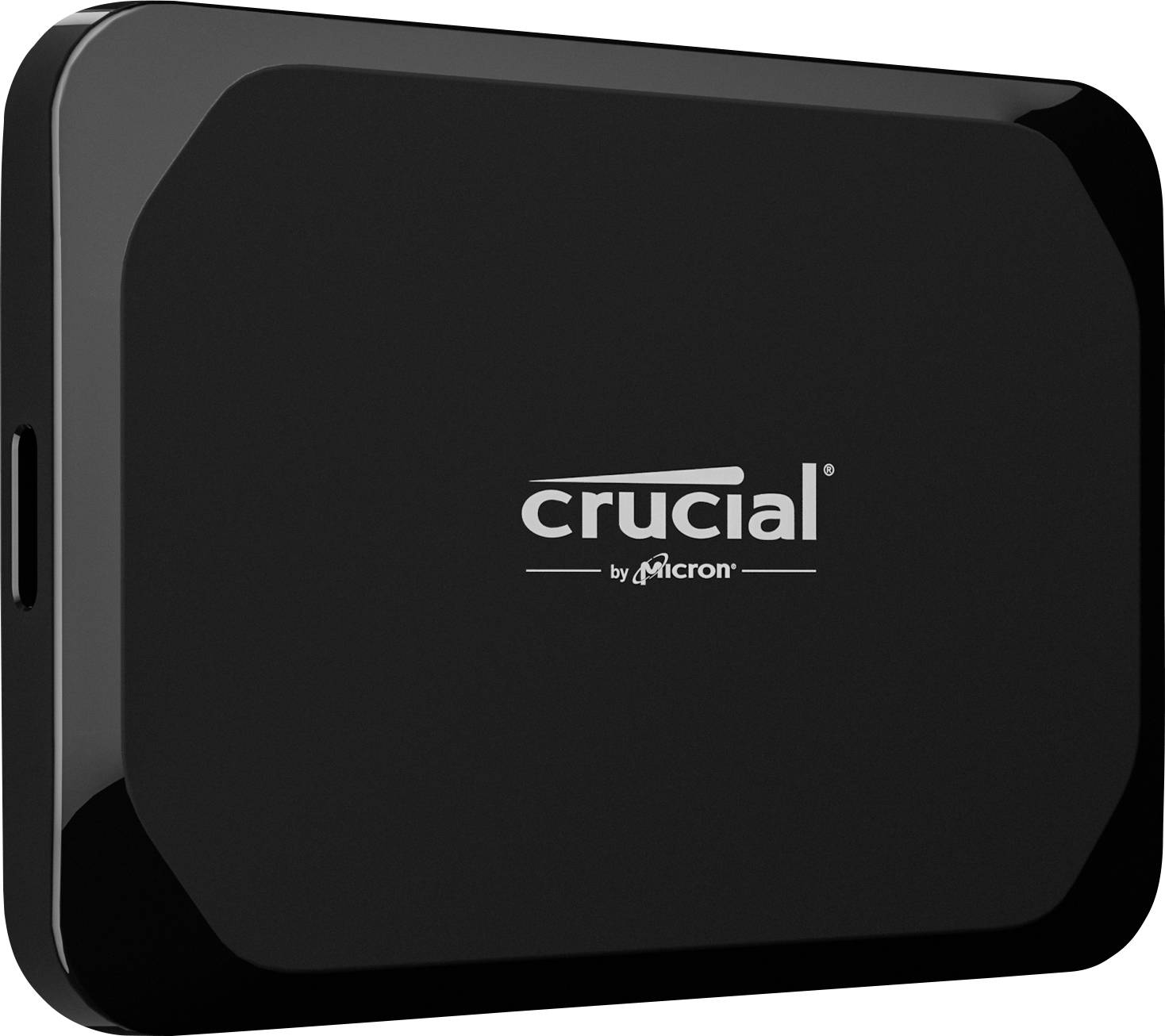 Disque dur externe noir portant l'inscription 'crucial by micron' au centre.