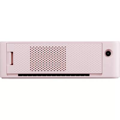 Un appareil électronique rose avec une grille de ventilation à l'avant et un port sur le côté droit.