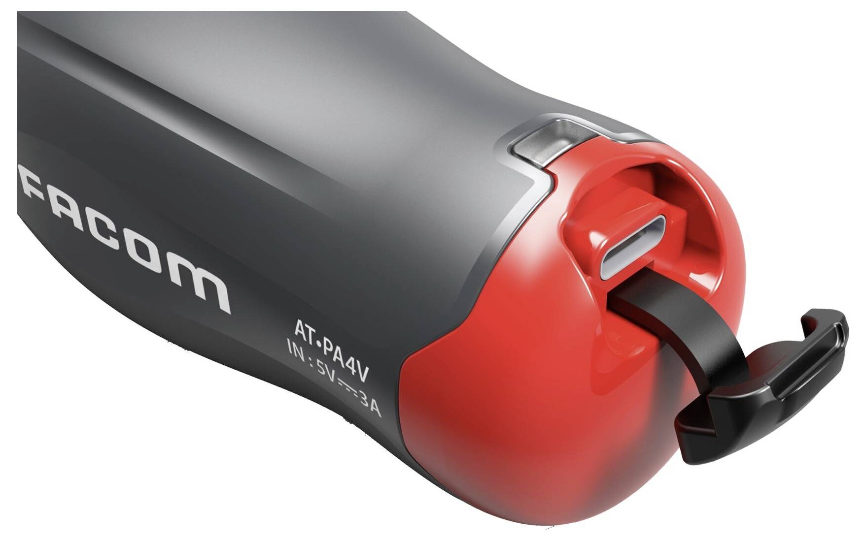 Un appareil électrique rouge et gris avec un câble, portant les inscriptions 'FACOM' et 'AT-PA4V IN: 5V-2.3A', probablement un chargeur ou un outil.
