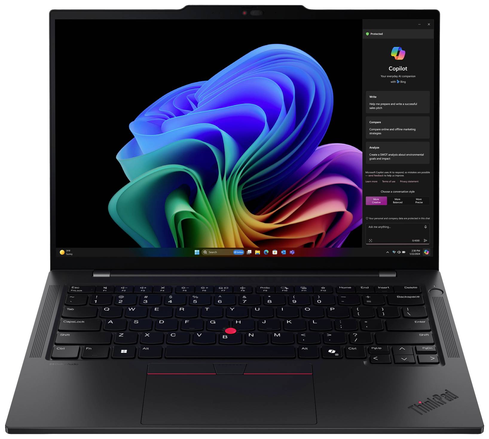 Un ordinateur portable noir affiche l'écran de démarrage de Windows avec un arrière-plan abstrait et coloré.