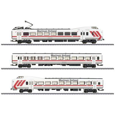 Deux wagons blancs de train miniature et une locomotive avec l'inscription 'Martinair Holland' et des bandes rouges sur une voie ferrée.