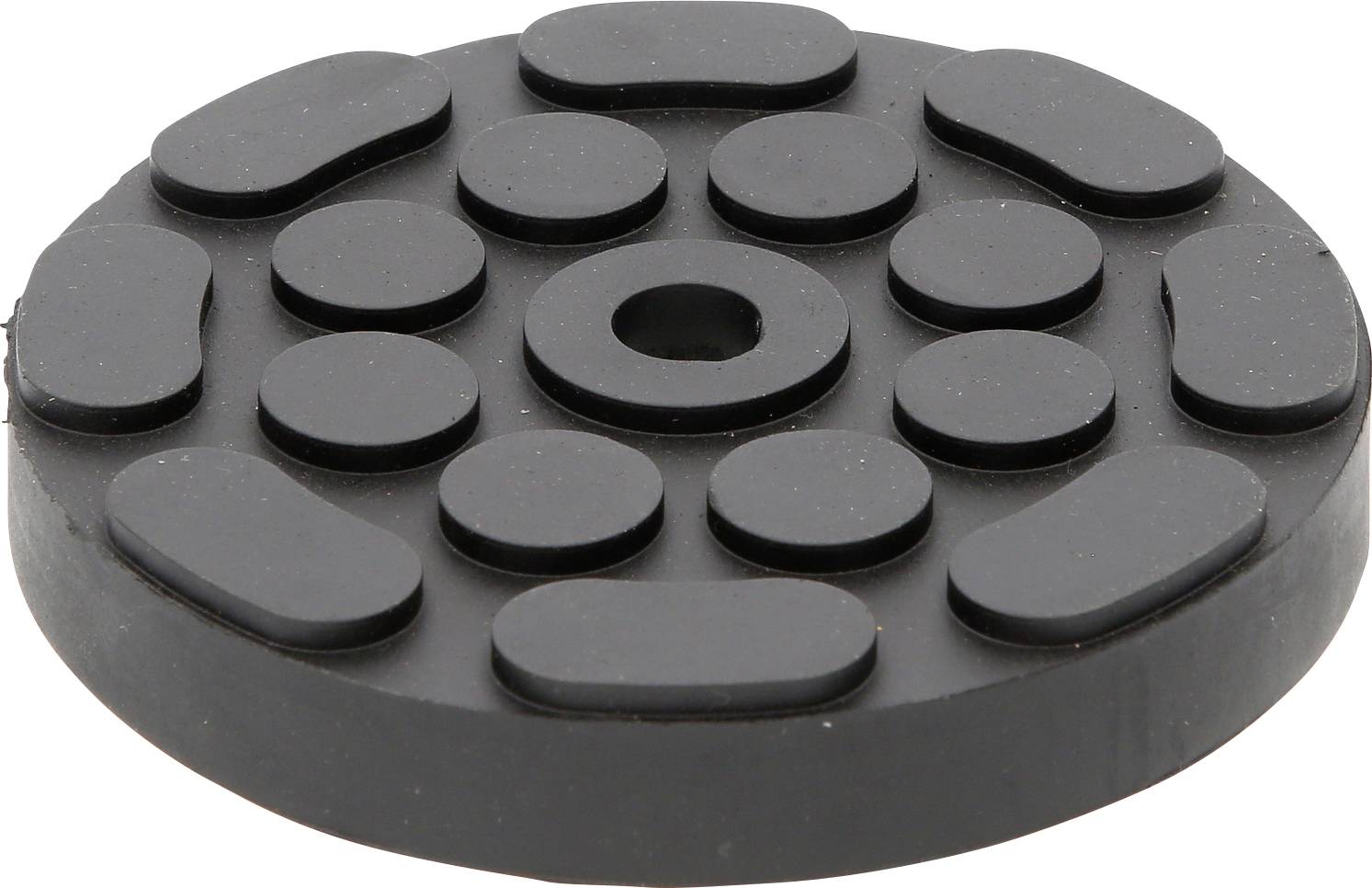Disque de caoutchouc noir et rond comportant plusieurs éléments ovales et circulaires en relief, disposés de manière radiale.