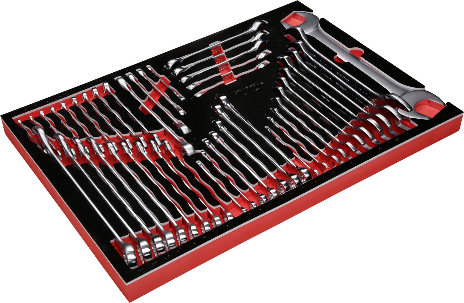 Un ensemble de clés à molette de différentes tailles, soigneusement rangé dans une boîte à outils avec des compartiments noirs et rouges.
