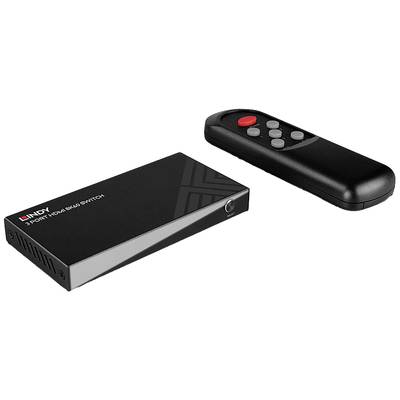 Un commutateur HDMI noir à trois ports avec télécommande. Le commutateur porte l'inscription 'Lindy Commutateur HDMI 3 ports'.