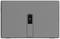 Objet rectangulaire gris avec un petit creux au centre ; le design paraît minimaliste.