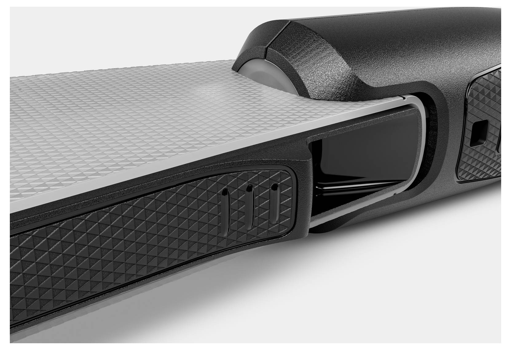 Un gros plan d'un appareil électronique élégant à surface texturée sombre, mettant en valeur son design moderne et ses caractéristiques high-tech.