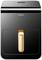 Un distributeur Panasonic noir avec une poignée couleur bronze, design rectangulaire, commandes simples sur le dessus.