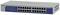 Switch réseau avec 24 ports Ethernet et voyants LED sur la façade. Nom de la marque visible sur le boîtier.