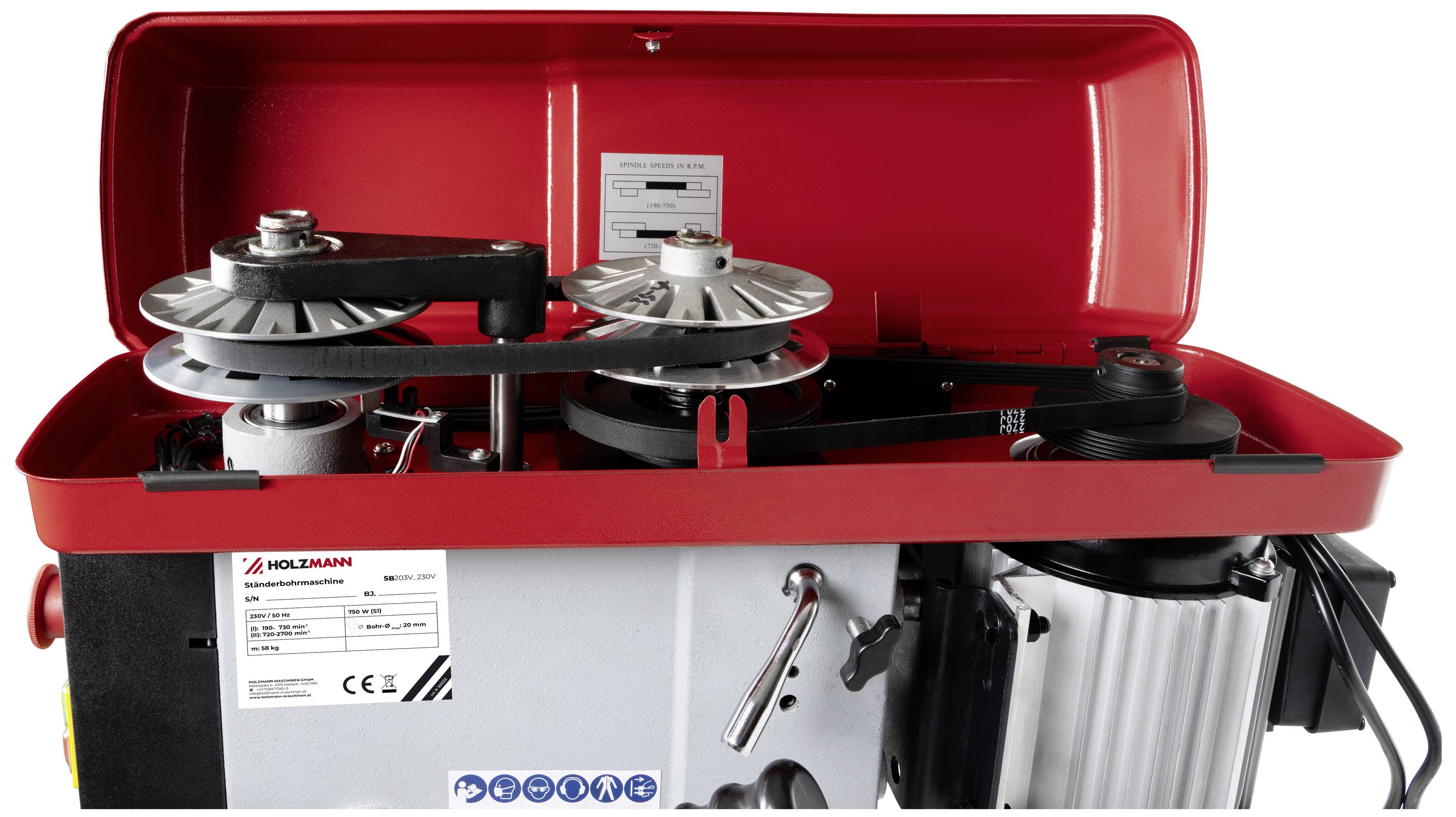 Une machine ouverte rouge montre deux poulies de renvoi et un moteur. Une plaque signalétique avec des détails techniques est visible.