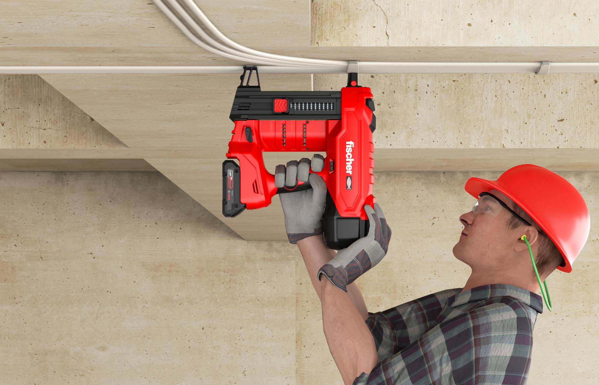 Un ouvrier de construction portant un casque de sécurité utilise un pistolet à clous rouge pour fixer des câbles à une poutre de plafond.