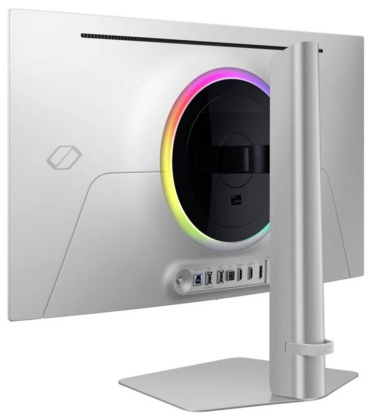 Un moniteur argenté vu de dos avec un anneau lumineux LED circulaire aux couleurs arc-en-ciel autour du support. Plusieurs possibilités de connexion en bas.