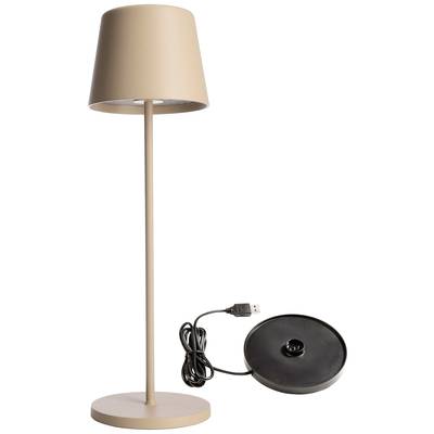 Une lampe de table élégante, beige, avec un socle rond ; à côté, un chargeur noir avec un câble USB.