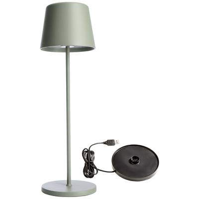 Lampadaire vert et élancé avec un socle rond. Un câble USB et une plaque de chargement sont disposés à côté.