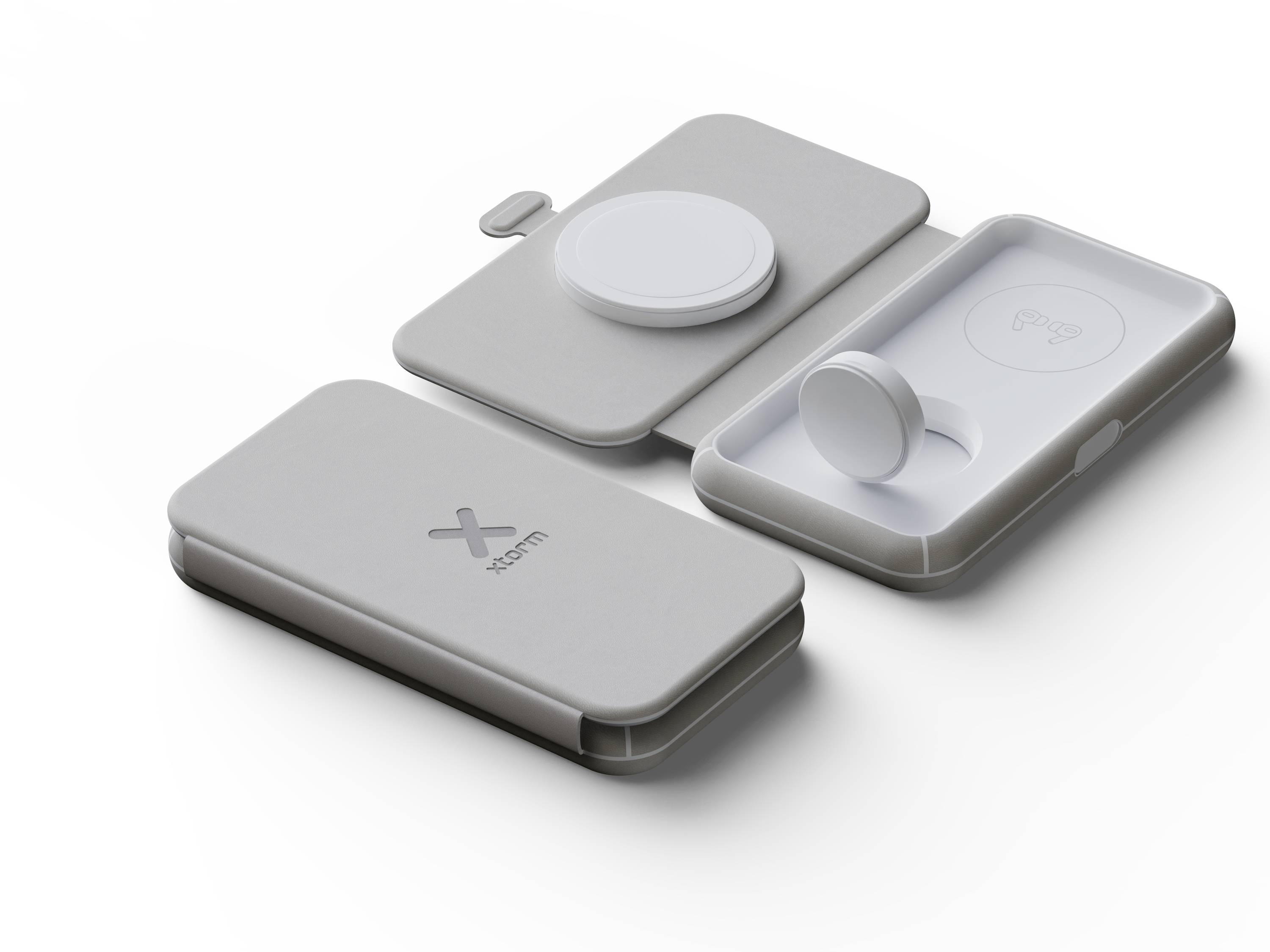 Trois étuis gris pour chargeurs sans fil, l'un ouvert laissant voir le chargeur, l'autre fermé, sur fond blanc.