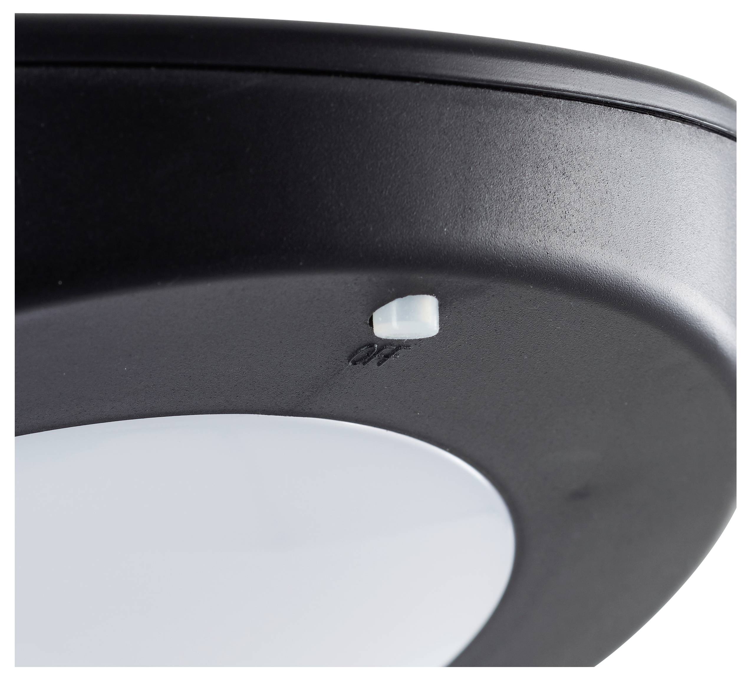 Gros plan sur un pied de canapé noir avec un détail en plastique rond à sa base, semblant être un embout de protection.