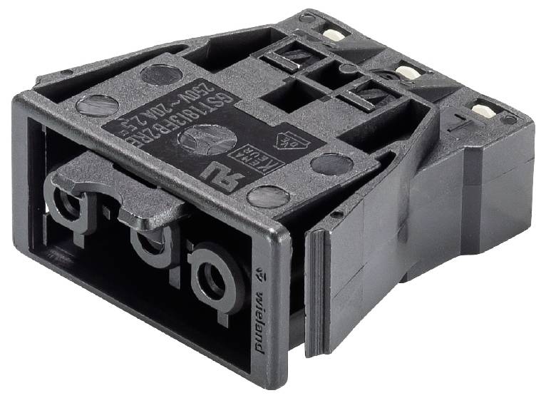 Composant électrique noir, probablement un connecteur ou un interrupteur, avec deux trous de fixation et des marquages techniques.