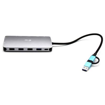 Un hub USB argenté avec quatre ports et une clé USB bleue, connecté par un câble noir.