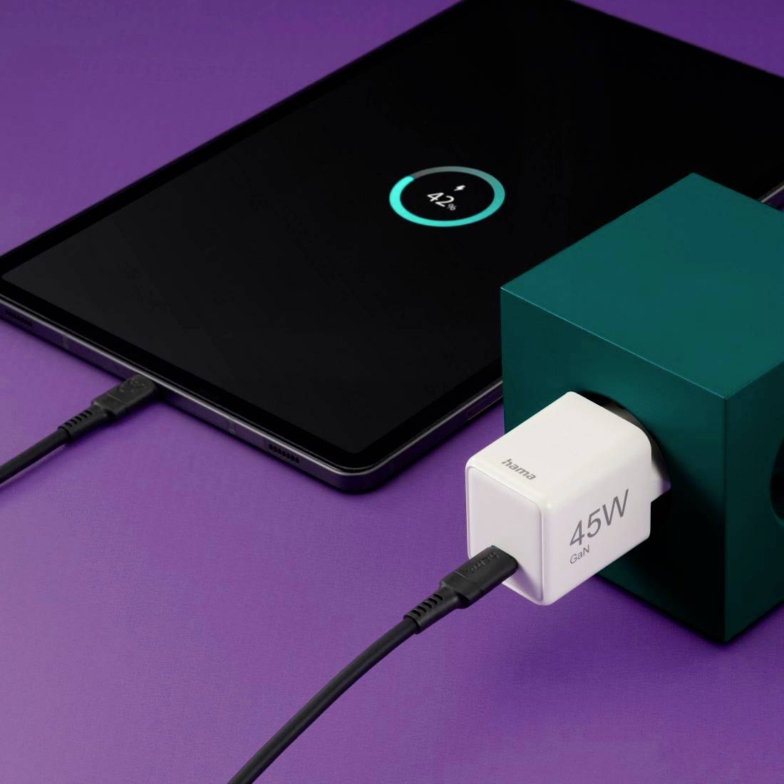 Une tablette est en cours de charge avec un chargeur GaN de 45W sur un fond violet.