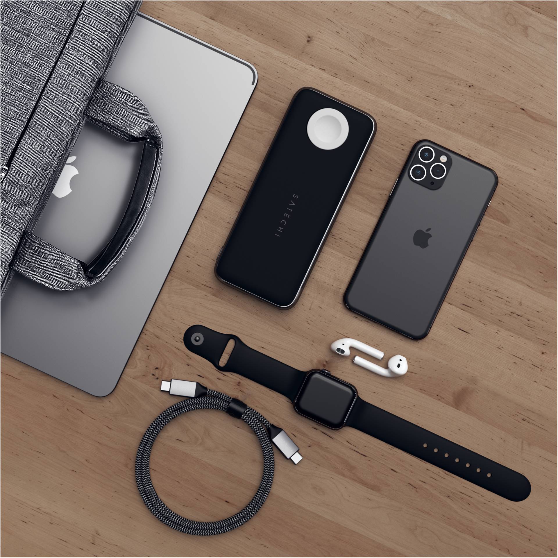 Ordinateur portable, smartphone, montre connectée, AirPods et chargeurs sur une table en bois. Technologie, accessoires et sacoche harmonieusement disposés.