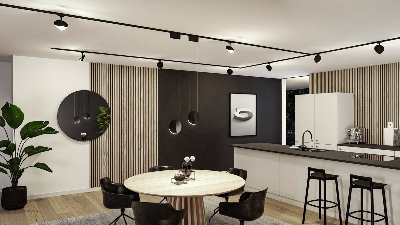 Cuisine moderne avec table à manger et quatre chaises. Armoires noires et blanches, plantes et lampes suspendues. Aménagement simple et élégant.