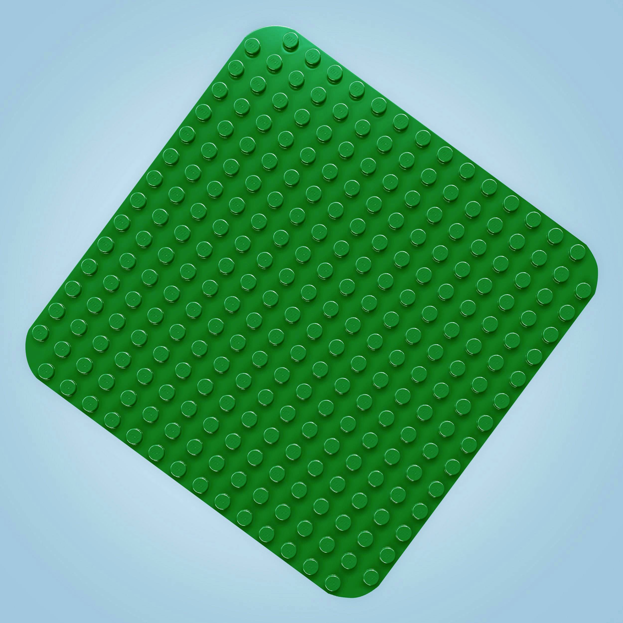 Un bloc de construction en plastique vert avec des picots sur un fond bleu.