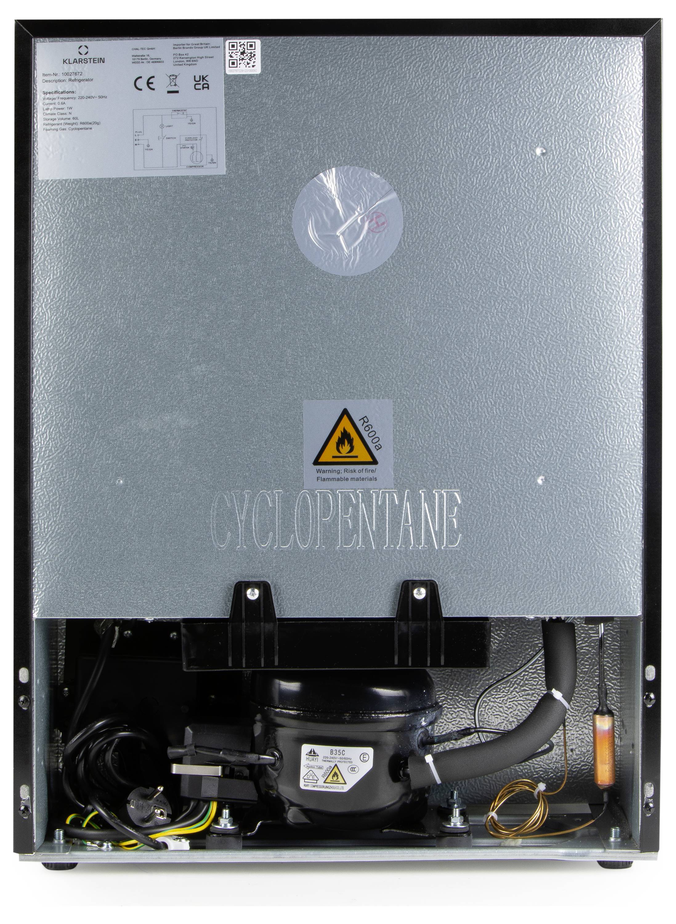 Dos d'un réfrigérateur avec compresseur intégré visible. Avertissement de danger électrique. Inscription 'Cyclopentane'.