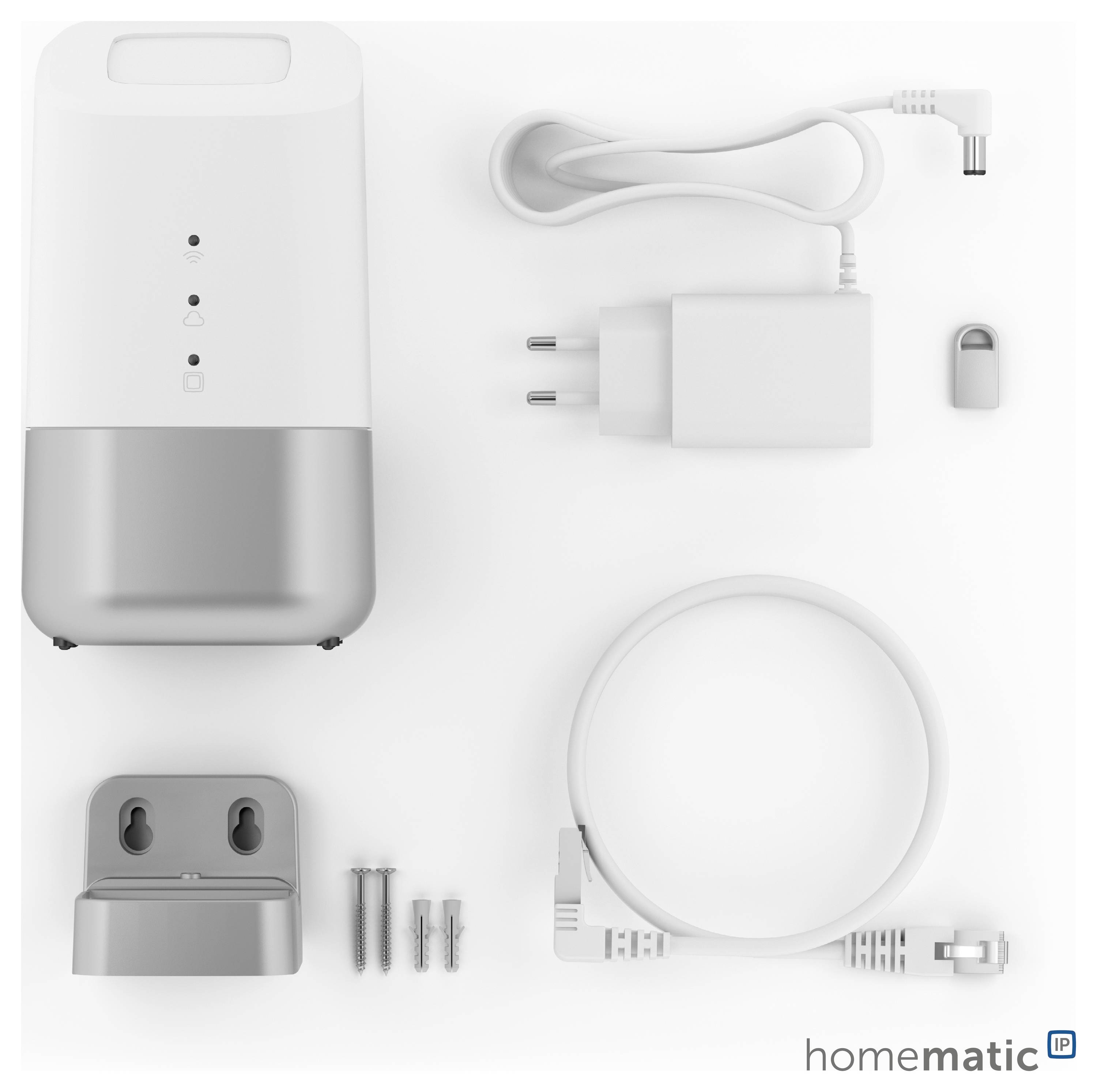 Appareil domotique Homematic IP avec accessoires : appareil principal, câble de charge, bloc d'alimentation, support mural, vis, et un petit adaptateur.