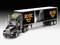 Un camion noir avec remorque, portant le logo du groupe AC/DC et l'inscription 'PWR/UP Tour', présente un design de scène avec un guitariste.
