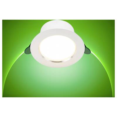 Un luminaire de plafond brillant brille sur un fond vert éclatant.