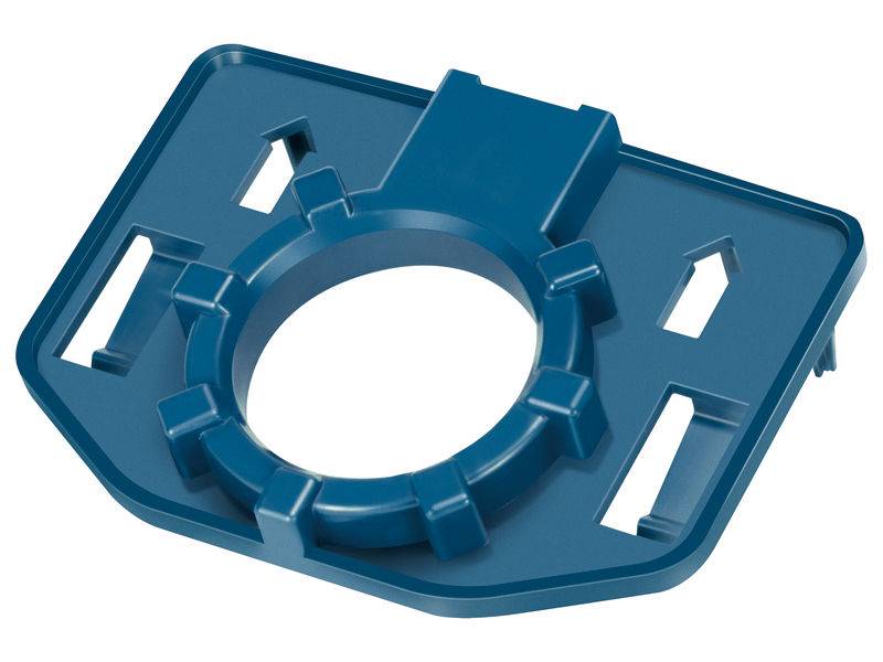 Pièce en plastique bleu avec une partie centrale arrondie et une forme de base rectangulaire, probablement un adaptateur ou un support, avec des ouvertures vides visibles.
