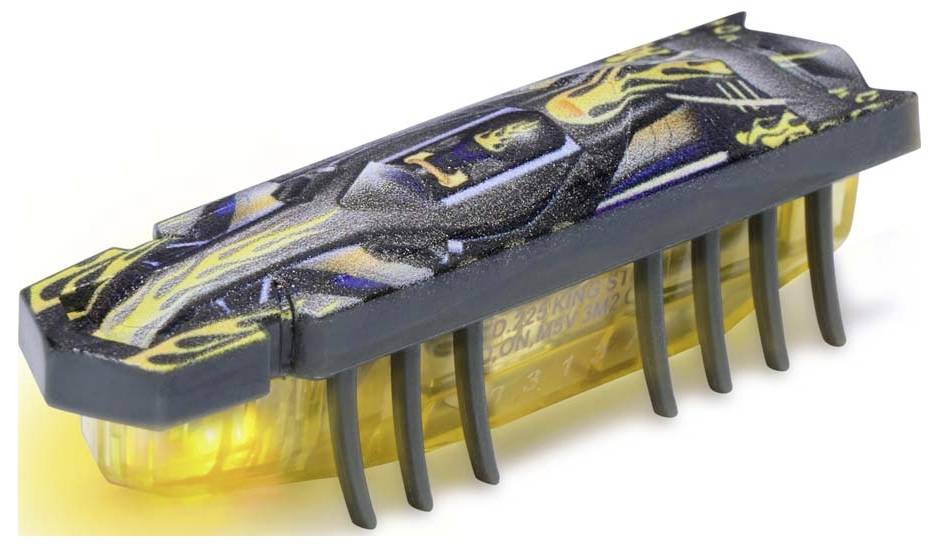 Un minuscule robot à l'image d'un scarabée, doté de LED et d'un motif artistique sur sa surface supérieure, éclairé en jaune par en dessous.