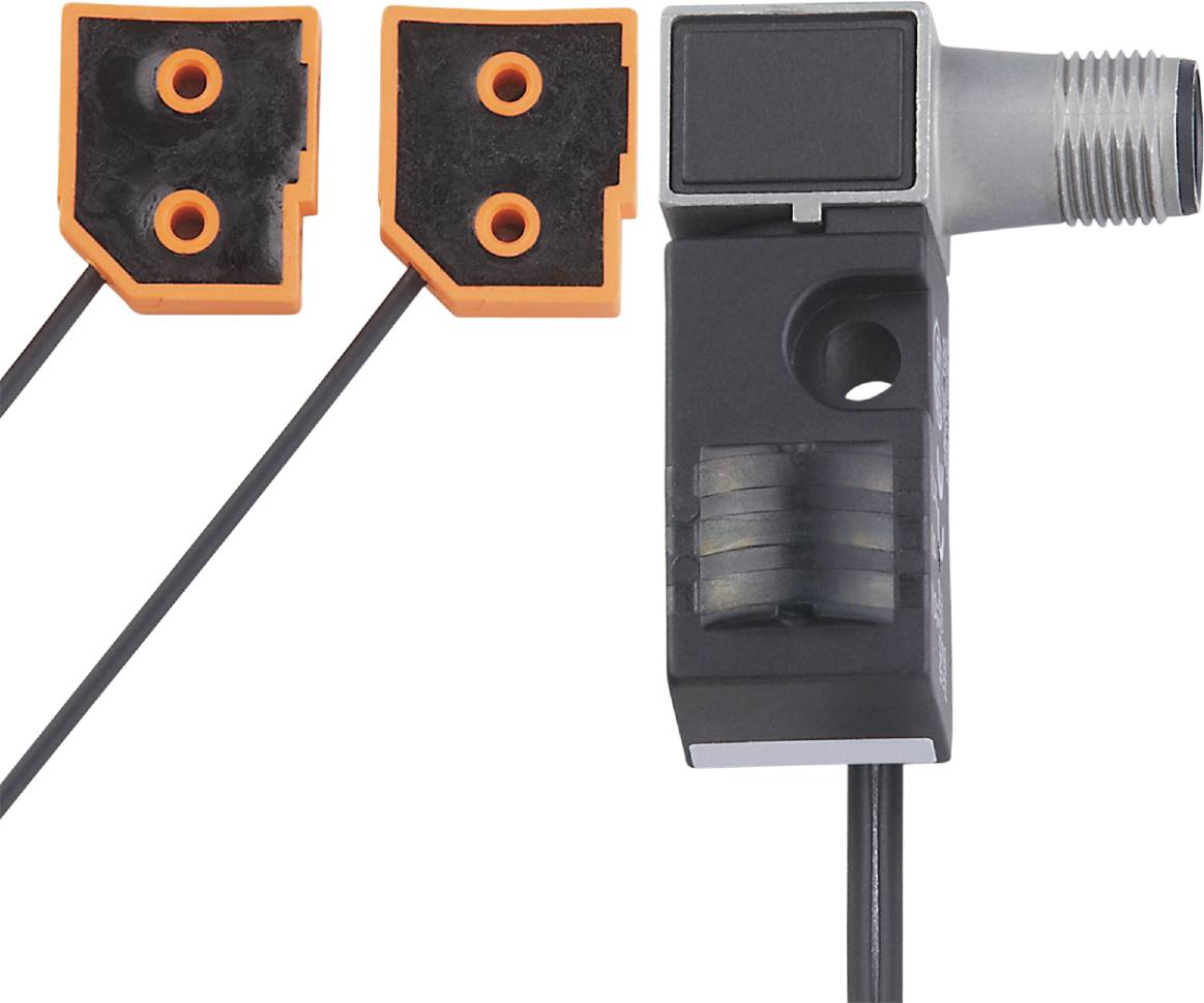 Un capteur magnétique en gris avec deux connexions de câbles orange détachées en haut, montrant les connexions électriques.